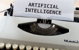 The words artificail intelligence written on a piece of paper inside a typewritter